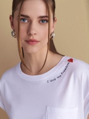 Λευκό βαμβακερό κοντομάνικο t-shirt, με κλειστή στρογγυλή λαιμόκοψη, σε τετράγωνη γραμμή, με τετράγωνη τσέπη μπροστά και κεντημένο λογότυπο "I love my freedom"Attrattivo  