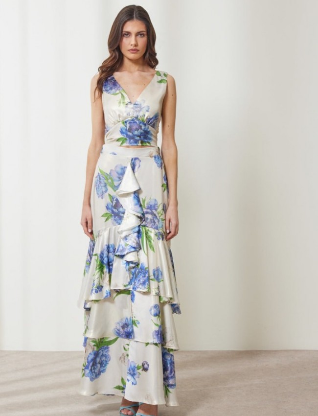 Floral printed μπλε μεταλλιζέ maxi Aubrey φούστα, με βολάν σε επίπεδα, κάθετο βολάν με μπροστινό σκίσιμο, λάστιχο πίσω στην μέση και κλείσιμο με κρυφό φερμουάρ στο πλάι Enzzo  