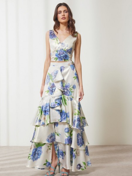 Floral printed μπλε μεταλλιζέ maxi Aubrey φούστα, με βολάν σε επίπεδα, κάθετο βολάν με μπροστινό σκίσιμο, λάστιχο πίσω στην μέση και κλείσιμο με κρυφό φερμουάρ στο πλάι Enzzo  
