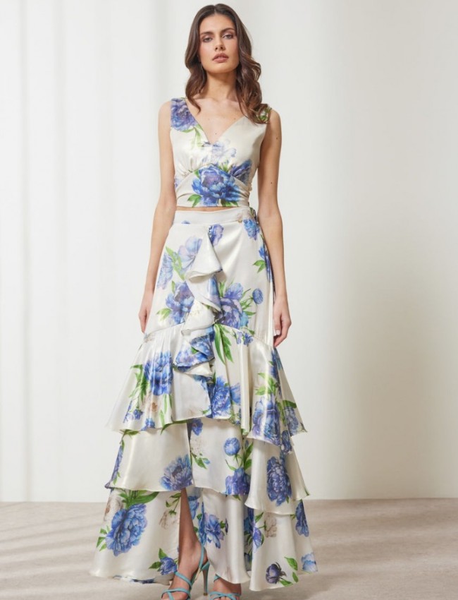 Floral printed μπλε μεταλλιζέ maxi Aubrey φούστα, με βολάν σε επίπεδα, κάθετο βολάν με μπροστινό σκίσιμο, λάστιχο πίσω στην μέση και κλείσιμο με κρυφό φερμουάρ στο πλάι Enzzo  